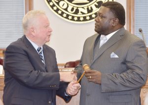  PASSING OF THE GAVEL—2016 Dillon County Council Chairman T.F. “Buzzy” Finklea, Jr., passes the gavel to Robert Archie Scott, who was elected as the 2017 Chairman in a 4-3 vote on Tuesday. Finklea congratulated Scott and said he was very qualified and would make a good chairman. Councilman Stevie Grice was elected as vice-chairman. He also received four votes to win the vice-chairmanship. (Photo by Johnnie Daniels/The Dillon Herald) 