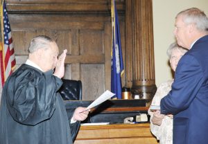 JUDGE JAMES E. LOCKEMY administers the oath of office to Sheriff Major Hulon, who was re-elected for another term. Pictured holding the Bible is his wife, Cynthia. (Photo by Johnnie Daniels/The Dillon Herald)