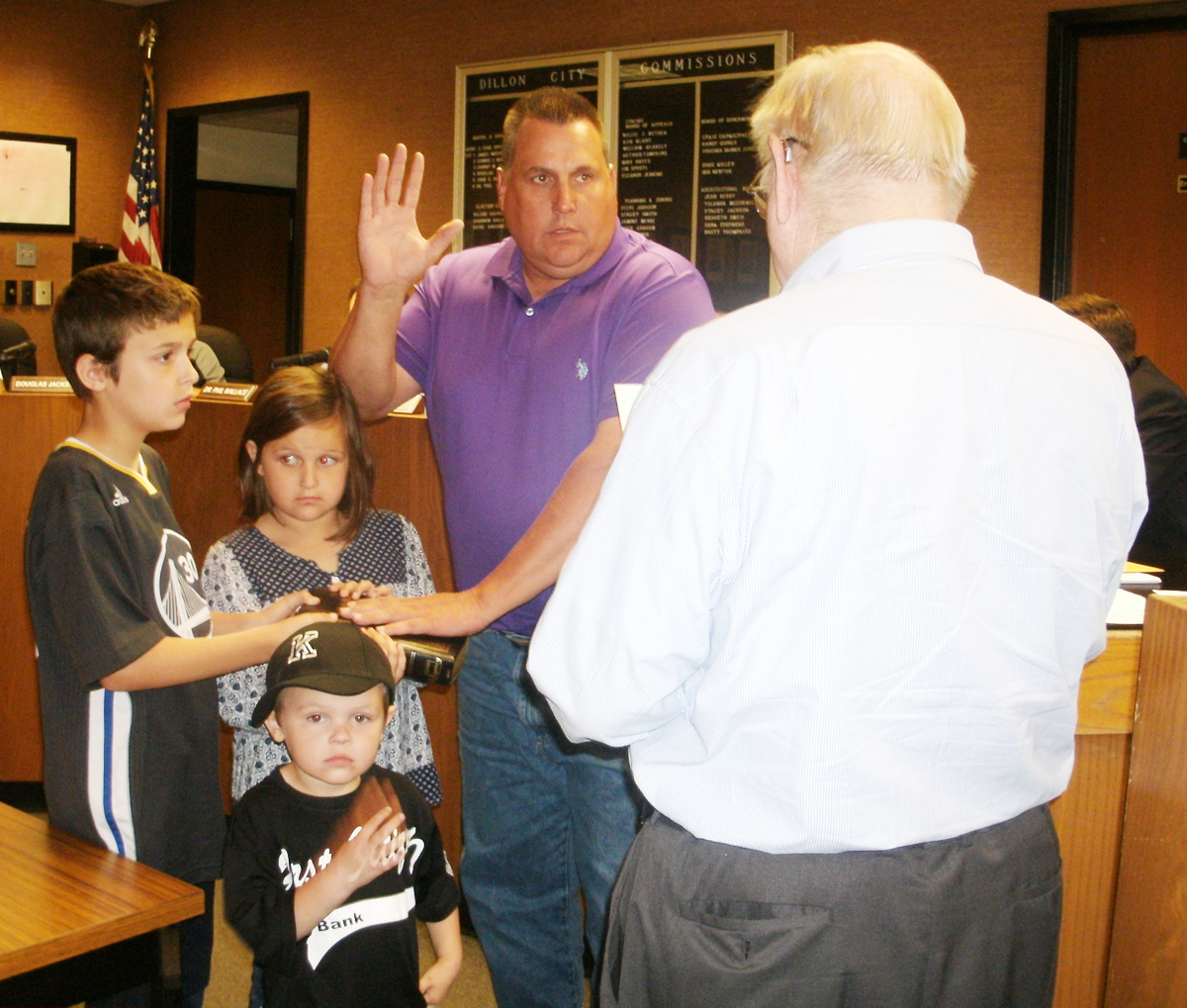 COUNCILMAN JOHNNY ELLER takes the oath of office as his children Ethan, Haidan, and Easton stand with him. The oath was administered by City Attorney Jack McInnis. (Photo by Betsy Finklea/The Dillon Herald