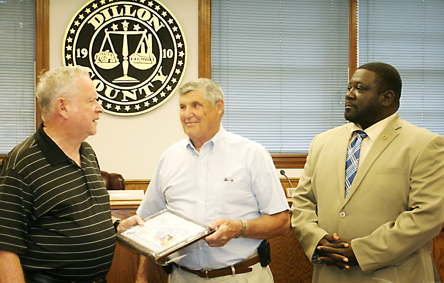 Councilman T.F. "Buzzy" Finklea, Jr., and Chairman Archie Scott present a plaque to Henry Brunson of Cooks for Christ.