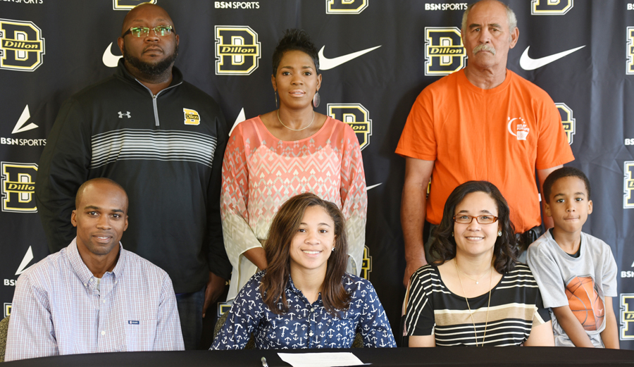 Khamele Manning surrounded by family and coaches on her signing day.